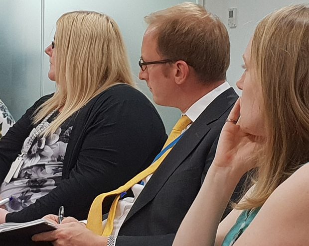 Three people (including SSAC members Victoria Todd and Carl Emmerson) listening at meeting 